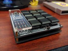 a computer keyboard sitting on top of a wooden desk