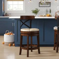 two stools in a kitchen with blue cabinets