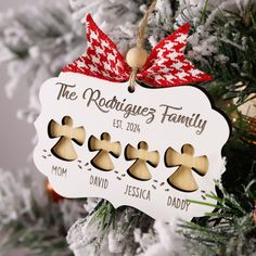 a christmas ornament hanging on a tree with gingerbreads in the shape of cookies