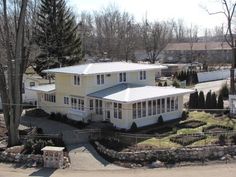 this is an aerial view of a house in the suburbs with many trees and shrubs around it