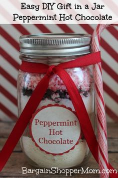 peppermint hot chocolate in a jar with candy canes on the side and text overlay that says easy diy gift in a jar peppermint hot chocolate