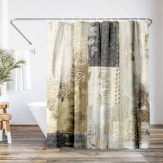 a bathroom with a shower curtain that has different colors and patterns on it, along with a plant in the corner