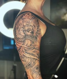 a woman's arm with a lion tattoo on it, and an intricate design