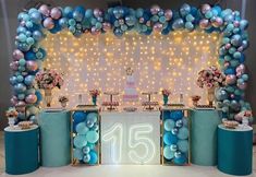 a decorated stage with balloons and cake