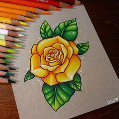 a drawing of a yellow rose surrounded by colored pencils