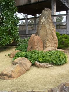 a rock and grass garden in front of a building