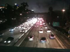 traffic is backed up on the freeway at night in this time lapse photo taken from an overpass