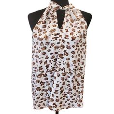 Imagine Transforming Your Wardrobe With The Perfect Blend Of Elegance And Wild Flairmeet The Pleione Taupe Brown Animal Twist Front Tie Back Halter Top. This Stunning Blouse, New With Tags, Features A Sophisticated Halter Neck With A Keyhole Detail, Exuding Confidence And Charm. The Luxurious Beige Background, Adorned With An All-Over Leopard Print In Shades Of Brown, Promises A Look That's Both Timeless And Trendy. Designed With A Loose And Flowy Fit, This Versatile Piece Seamlessly Transitions From Casual Brunches To Semi-Formal Evenings, Ensuring You Feel Comfortable And Chic No Matter The Occasion. Plus, With Our Commitment To Sustainability, You Can Feel Good About Your Purchase, Kno Spots Light, Tie Around Neck, Doll Blouse, Pink Tunic, Printed Sleeveless Blouse, Flowy Tops, Women Shirts Blouse, Twist Front, Brown Fashion