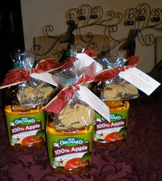 three jars filled with peanut butter and jelly sitting on top of a red table cloth