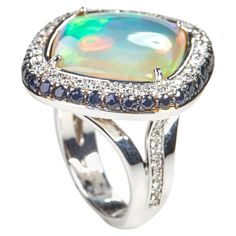 Beautiful 18 Karat white gold cocktail ring with white and black Sapphires biutiful opal This ring combines classical with modern elements and can be worn every day! 55 Diamonds0.70 carat GVS 50 Sapphire black 2.04 ct 1 Opal 7.72 ct. Size EU 53.5 US 6.5 Founded in 1974, Gianni Lazzaro is a family-owned jewelery company based out of Düsseldorf, Germany. Although rooted in Germany, Gianni Lazzaro's style and design is more reminiscent of Italian luxury and craftsmanship. The exquisite pieces and o Vintage Cocktail Ring, Gold Cocktail Ring, Black Sapphire, Gold Cocktail, Dusseldorf, Modern Ring, Italian Luxury, Cocktail Ring, Modern Jewelry