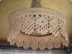 a crocheted lamp shade hanging from a ceiling