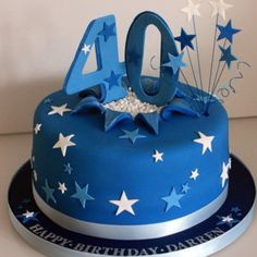 a blue birthday cake with white stars on it and the number forty written in silver