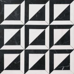 a black and white tiled wall with geometric shapes