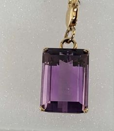 This Magnificent Natural Emerald Cut Purple Amethyst Solitaire Pendant is crafted from the finest 14kt yellow gold. Its pristine condition and 4.0 dwt weight lend an air of sophistication to this exquisite custom piece, showcasing the excellent emerald-cut purple impressive amethyst gemstone in a timeless solitaire style. Its gleaming polish finish and exquisite workmanship make this a luxurious choice. Amethyst Size: 17mm X 14mmTotal Weight: 4.0 dwt. Stamped: 14KQuality guaranteedGift BoxedOnly Emerald Cut Amethyst Jewelry In Yellow Gold, Formal Amethyst Pendant Gemstone, Exquisite Amethyst Pendant Necklace, Faceted Amethyst Pendant Crystal Necklace, High-end Faceted Amethyst Necklaces, Solitaire Pendant, Amethyst Pendant, Natural Emerald, Amethyst Gemstone