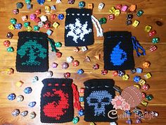 several crocheted items are laid out on the floor next to each other and some beads