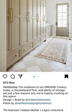 a large white room with lots of cabinets and rugs on the floor in front of it