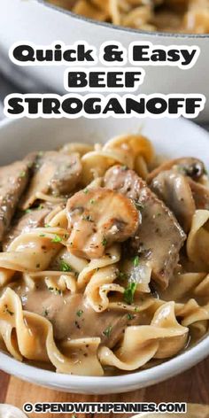 a white bowl filled with beef and mushroom stroganoni on top of a wooden table