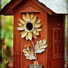 a bird house with a sunflower on it