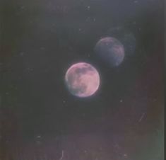 two pink moon are seen in the night sky