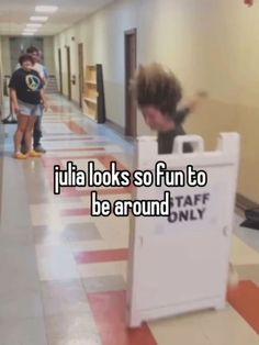 two kids are walking down the hallway with luggage bags on their back and one is leaning against a sign that says julia looks so fun to be around