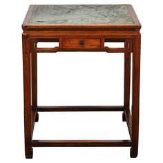 a small wooden table with marble top and drawer on one side, against a white background