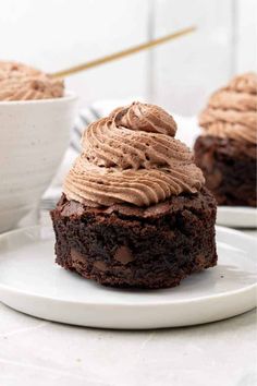 chocolate cupcakes with frosting on a white plate