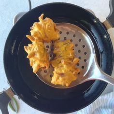 some food is being cooked in a frying pan on the stove top and ready to be eaten