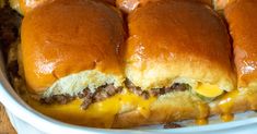 cheeseburger sliders in a casserole dish with melted cheese on top