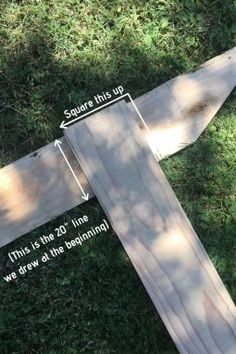 a wooden plank laying on top of green grass