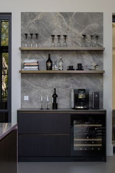 a bar with wine glasses and bottles on it