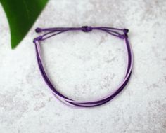 "Simple, yet stylish this 6 strand waxed cord bracelet is 100% waterproof you can shower and swim with it on without taken it off. It is adjustable and fits size 5-9\" wrists STYLE INCLUDES: * 100% waterproof * Purple and Light Purple * Adjustable 5-9\" * Perfect for: Women, Men and Children // Cancer awareness, ride/run for a cause, fundraisers, everyday wear * Cheap shipping MATERIAL: * Polyester Waxed Cord DESIGN YOUR OWN BRACELET: * Select 'Custom' from the drop down menu * In the note to se Adjustable String Bracelet, Wax Cord Bracelet, Bracelet Friendship, Cord Bracelet, String Bracelet, Cord Bracelets, Beach Jewelry, Adjustable Bracelet, Multi Strand