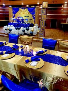 a table set up with blue and white decorations