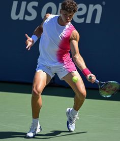 a male tennis player in action on the court