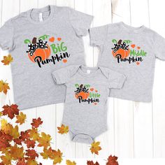 Stop traffic with all the cuteness a family can muster up with Trendy Custom Apparel's Fall Girl's Matching Sibling Thanksgiving Pumpkin Graphic Print T-Shirt! Bring joy to your home this fall and go pumpkin picking in style. These quality T-shirts, crafted from 100% soft cotton and pre-shrunk Gildan brand, are stylish and comfortable. Choose your own matching sister design in big pumpkin, middle pumpkin, or little pumpkin. With a multi color design to choose from, from bright soft flex vinyl co Playful T-shirt For Fall Playtime, Playful T-shirt For Playtime In Fall, Cute Fall T-shirt For Playtime, Playful Fall T-shirt With Cartoon Print, Fall Playtime Tops With Short Sleeves, Black Family Matching T-shirt For Playtime, Big Pumpkin, Biggest Pumpkin, Black Onesie