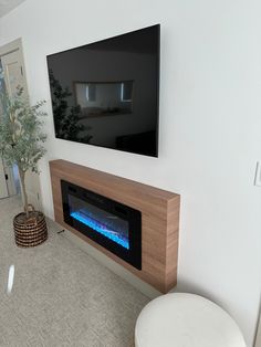 a television mounted on the wall above a fireplace