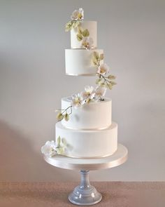 three tiered wedding cake with white flowers on top