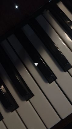 an apple logo is placed on the keys of a piano