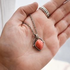 You get a truly unique LBJ design with this "Basket" Pendant -- here in fantastic Spiny Oyster. This piece is great for every day -- dainty, with the perfect pop of Chili Red Spiny Oyster and an exotic and interesting feel. You will wear this all the time. Pendant is paired in photos with our favorite, .925 sterling silver chain. -- 2.3 mm heavy cable chain with a nice large clasp and 2 inch extender. Spiny Oyster 'Kite" shape (12X15mm) .925 Sterling Silver Balance Optional Chain is .925 Sterlin Untreated Red Sterling Silver Jewelry, Unique Orange Sterling Silver Necklace, Unique Orange Jewelry For Gifts, Unique Orange Jewelry For Gift, Sterling Silver Untreated Teardrop Pendant, Untreated Teardrop Pendant Necklace As A Gift, Artisan Untreated Jewelry As Gift, Untreated Teardrop Pendant Necklace For Gifts, Unique Red Everyday Jewelry