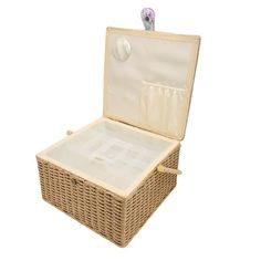 an empty wicker suitcase with lid open on a white background and clippings attached to it