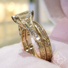 an engagement ring with a princess cut diamond set in it's setting on top of a pillow