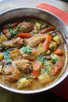 a pot filled with meat and vegetables on top of a table