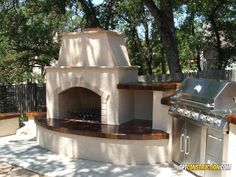 an outdoor pizza oven built into the side of a house