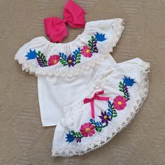 Beautiful Mexican Embroidered Blouses With Bloomer Also Embroidered, Hair Bow Included. Back Side Of The Off The Shoulder Blouse Isn’t Embroidered Only Front Side . Back Side Of The Bloomer Is Embroidered, Not The Front Side . Fabric: Cotton- Manta New- No Tags - Handmade I Recommend Ordering According To Infant Actual Age .. They Are Made Tru To Size Average Child Age . Hand Wash Only- Each Outfit Has Unique Colorful Embroidery. Embroidered Short Sleeve Summer Sets, Summer Embroidered Short Sleeve Sets, Cotton Beach Sets With Floral Embroidery, Beach Sets With Floral Embroidery In Cotton, Beach Embroidered Cotton Set, Embroidered Beach Sets For Spring, Cute Embroidered Cotton Sets, Summer Cotton Sets With Embroidered Hem, White Cotton Sets With Machine Embroidery