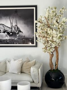 a living room filled with furniture and a painting on the wall