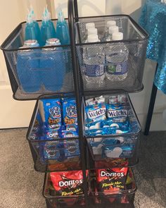 two baskets filled with drinks and snacks sitting on the floor