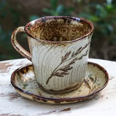 a cup and saucer sitting on top of a table