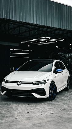 a white car parked in front of a building