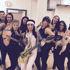 a group of women posing for a photo with guitars