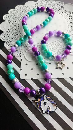 "Unicorn necklace set, kids jewelry, kids bracelet, party favor, purple, green, Unicorn jewellery, Unicorn jewelry. \" Be a Rainbow in someone else's cloud\" -Maya Angelou DETAILS and MEASUREMENT: Necklace: 20\" Bracelet: 6.5\" Made on stretchy cord. We can also put a clasp on it, for an extra $3.50 PLEASE NOTE: due to the high volume of orders, it is impossible for us to keep the same beads for all our orders, so the beads on your order may differ from the ones shown in the photo. if you would Green Unicorn, Jewelry Kids, Kids Bracelet, Bracelet Party, Unicorn Jewelry, Unicorn Necklace, Kids Bracelets, The One Show, Kids Necklace