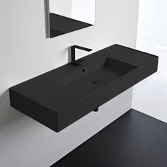 a black bathroom sink sitting under a mirror